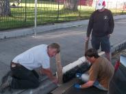 Locals painting curbs in Bridgeport