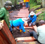 A group of volunteers are building a new puncheon to improve trail conditions.
