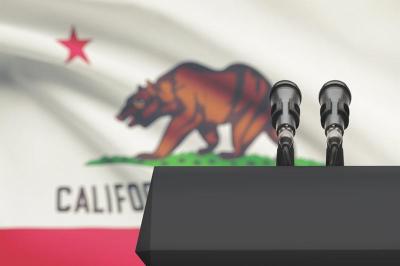 Image showing a podium in front of the CA State Flag